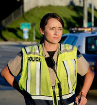 Female law enforcement officer in yellow vest