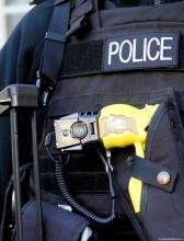 Police officer's vest with holstered Taser