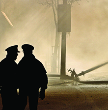 Two officers overlooking a disaster scene