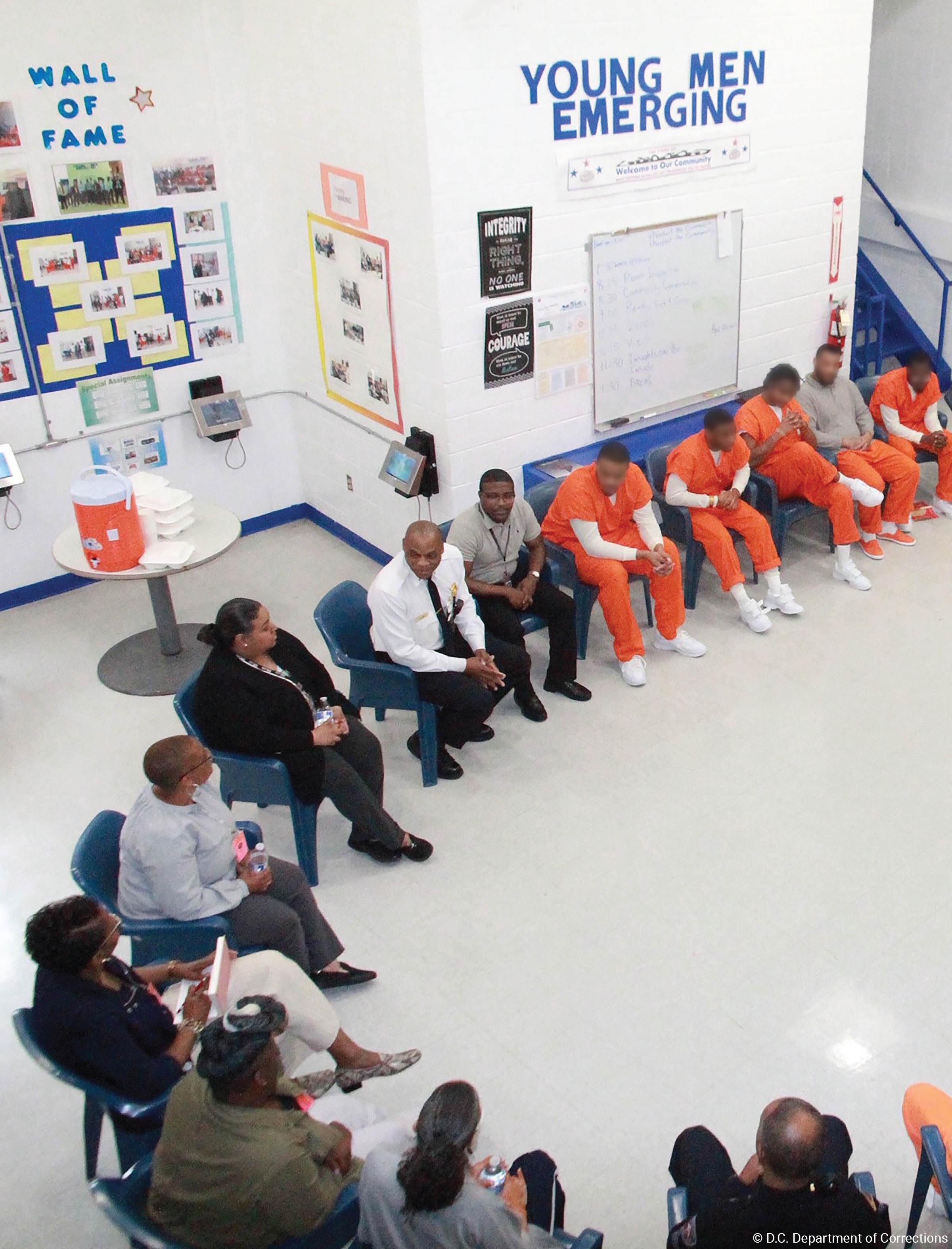 Inmates and program staff seated in a semi-circle