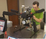 A researcher installs the Snoopy A-Series 60 LIDAR module on a small unmanned aircraft system.