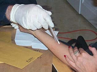 Image of technician using swab to collect evidence