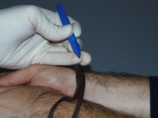 Image of technician collecting hair evidence