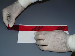 Image of evidence technician sealing a package