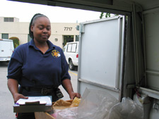 Photo of a woman organizing evidence in the back of a van