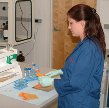 Lab Technician wearing gloves examining an envelope