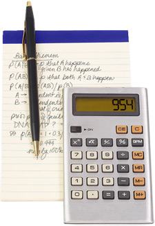 Photo of a notepad, a pen, and a calculator