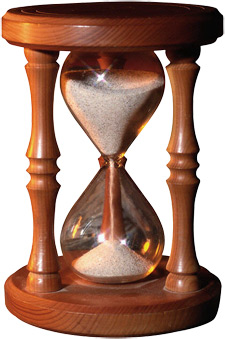 Photo of an hourglass full of sand at the top