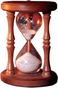 Photo of an hourglass where the sand has almost depleted