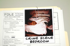 Photo of an open case file with a crime scene photo