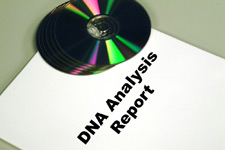 Photo of a DNA Analysis Report with 5 CD's on top of it