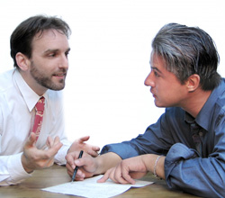 Photo of two men having a verbal conversation