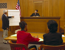 Photo of presenter in a courtroom