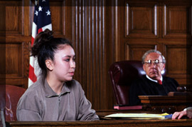 Photo of an expert witness appearing in front of a judge inside of a courtroom