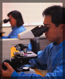 Photo of a chemist in a lab studying dna through a microscope