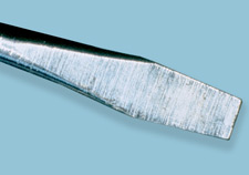 A flat-bladed tool (screwdriver)