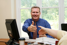 man in a blue shirt extending a handshake