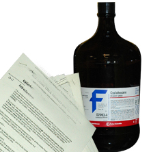 Image of bottled chemical next to hazard communication documents