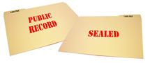 Two file folders, one says public record, one says sealed
