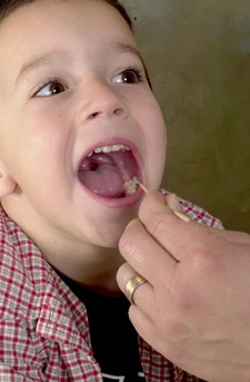 Photo of a child getting their mouth swabbed