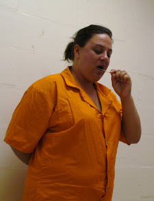 Photo of female inmate taking a DNA swab in the mouth