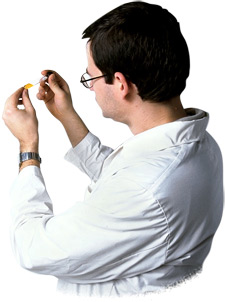 Photo of a scientist examining a test tube filled with liquid