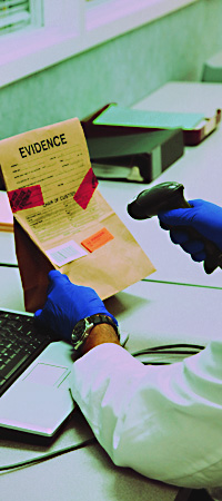 scientist scanning in a piece of evidence