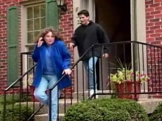 Photo of husband and wife running out of a house while yelling