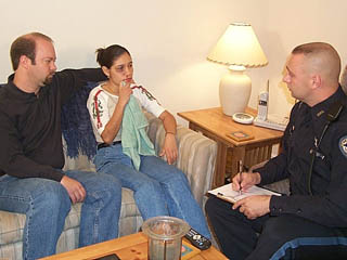 Photo of law enforcement officer conducting an interview