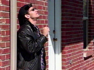 Photo of a man standing outside an apartment complex