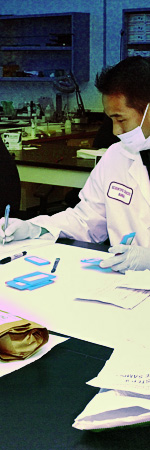 image of a lab technician writing something down