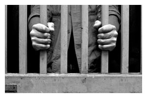 hands around prison bars
