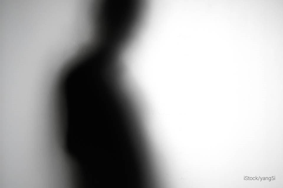 blurry photo of an outline of a shadowy person