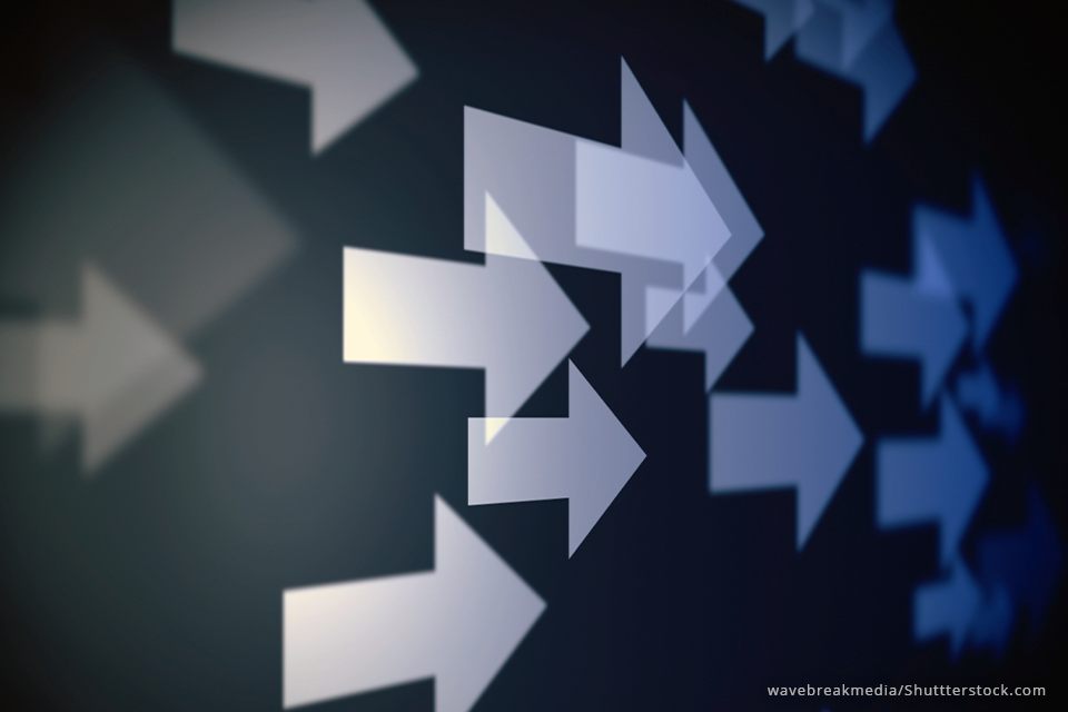 a group of blue arrows all pointing forward, to the right