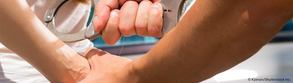 woman being put into handcuffs