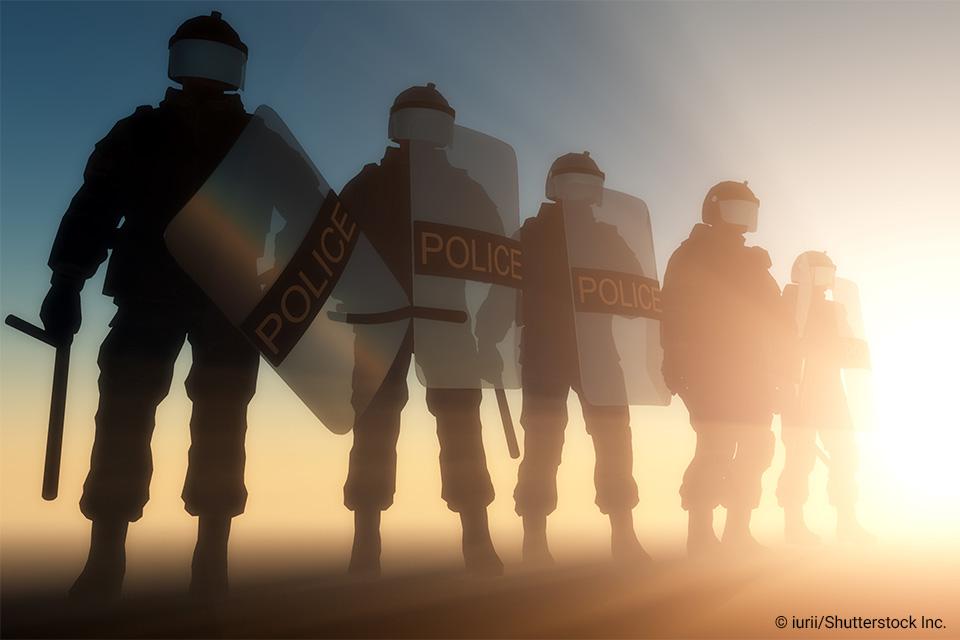 Police officers lined up in riot gear