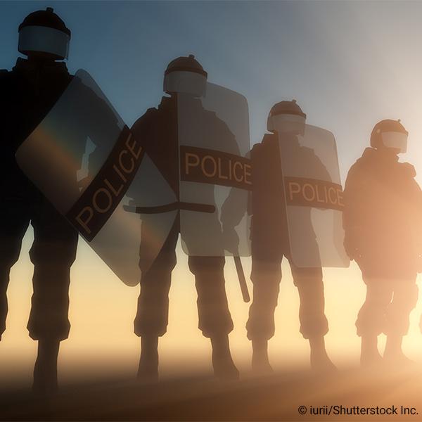 Police officers lined up in riot gear