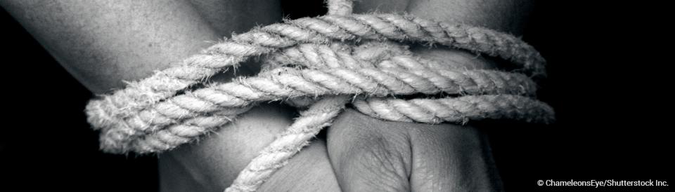 woman's hands and feet tied with rope
