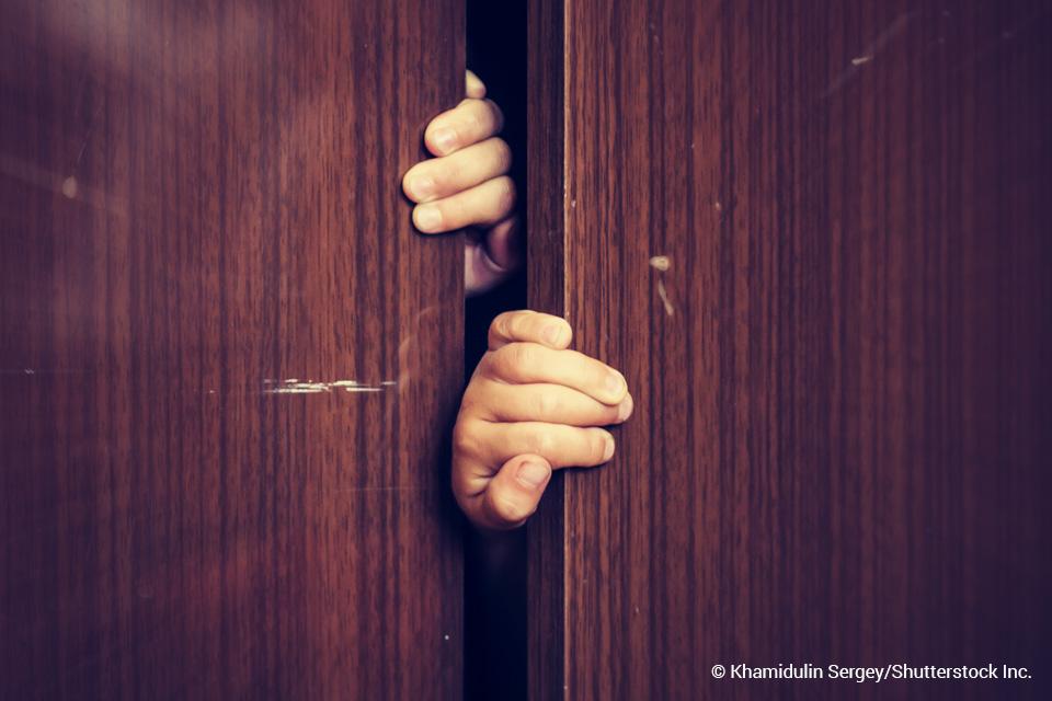 hand pulling open a door