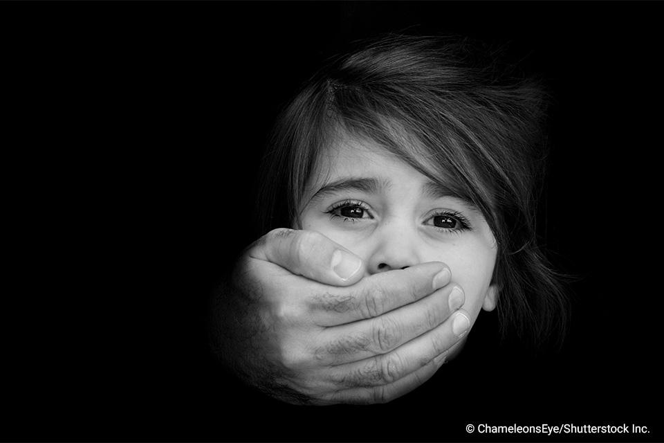 young girl with man's hand over her mouth