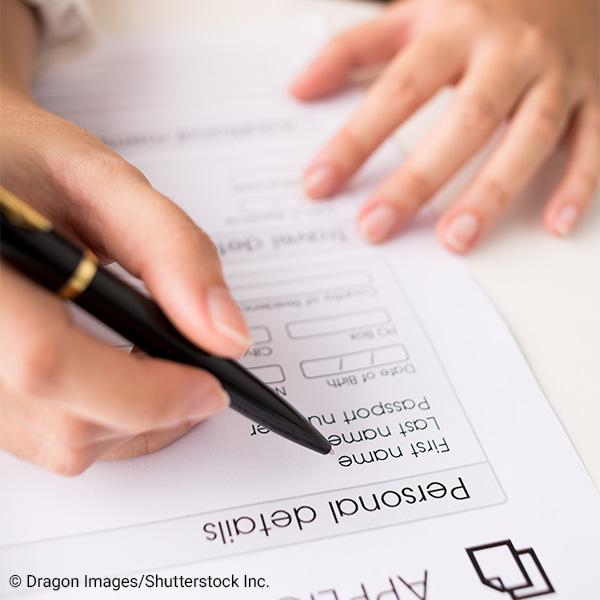 person filling out personal information on a form