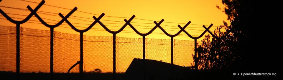 prison fencing at sunset