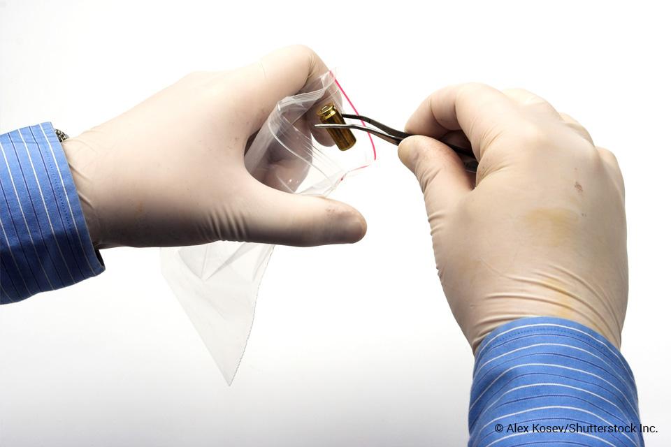 Crimes scene tech putting bullet casing in evidence bag