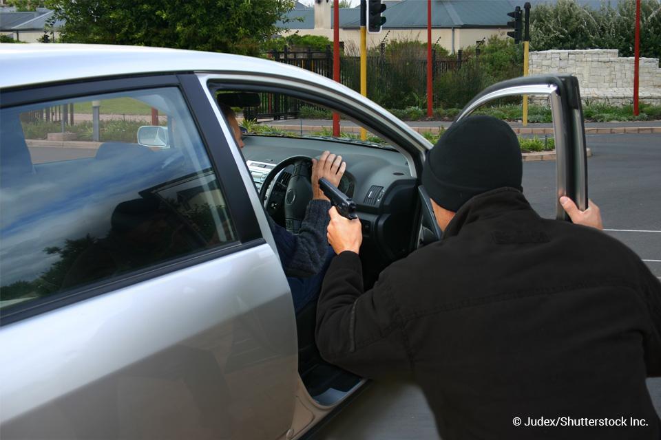 man with a gun carjacking someone
