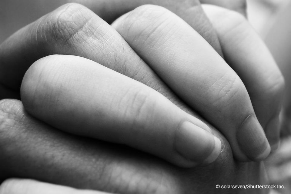 Interlaced fingers from two hands