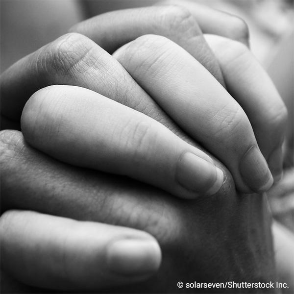 Interlaced fingers from two hands