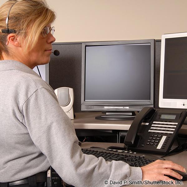 911 dispatcher at a desk