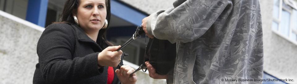 young man attempting to steal a woman's purse