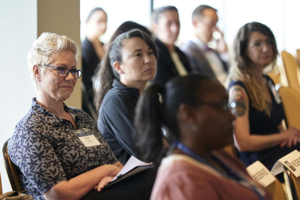 A diverse crowd listens to speakers at the NIJ 2023 Research Conference