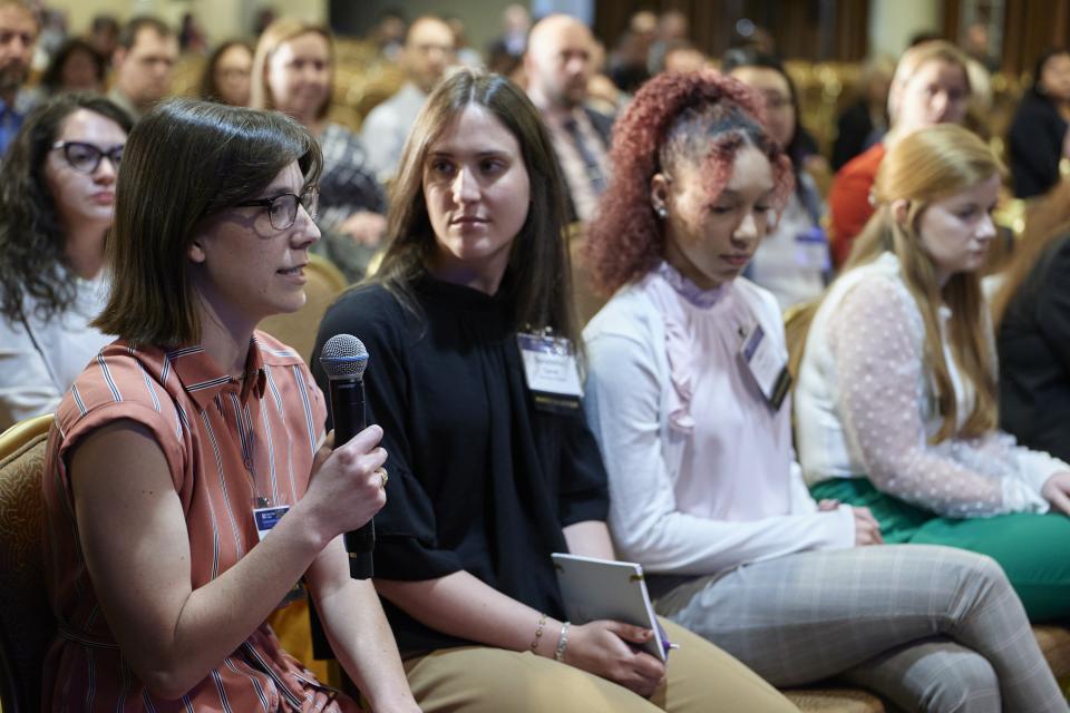 Women in the audience take part and ask questions at the NIJ 2023 Research Conference